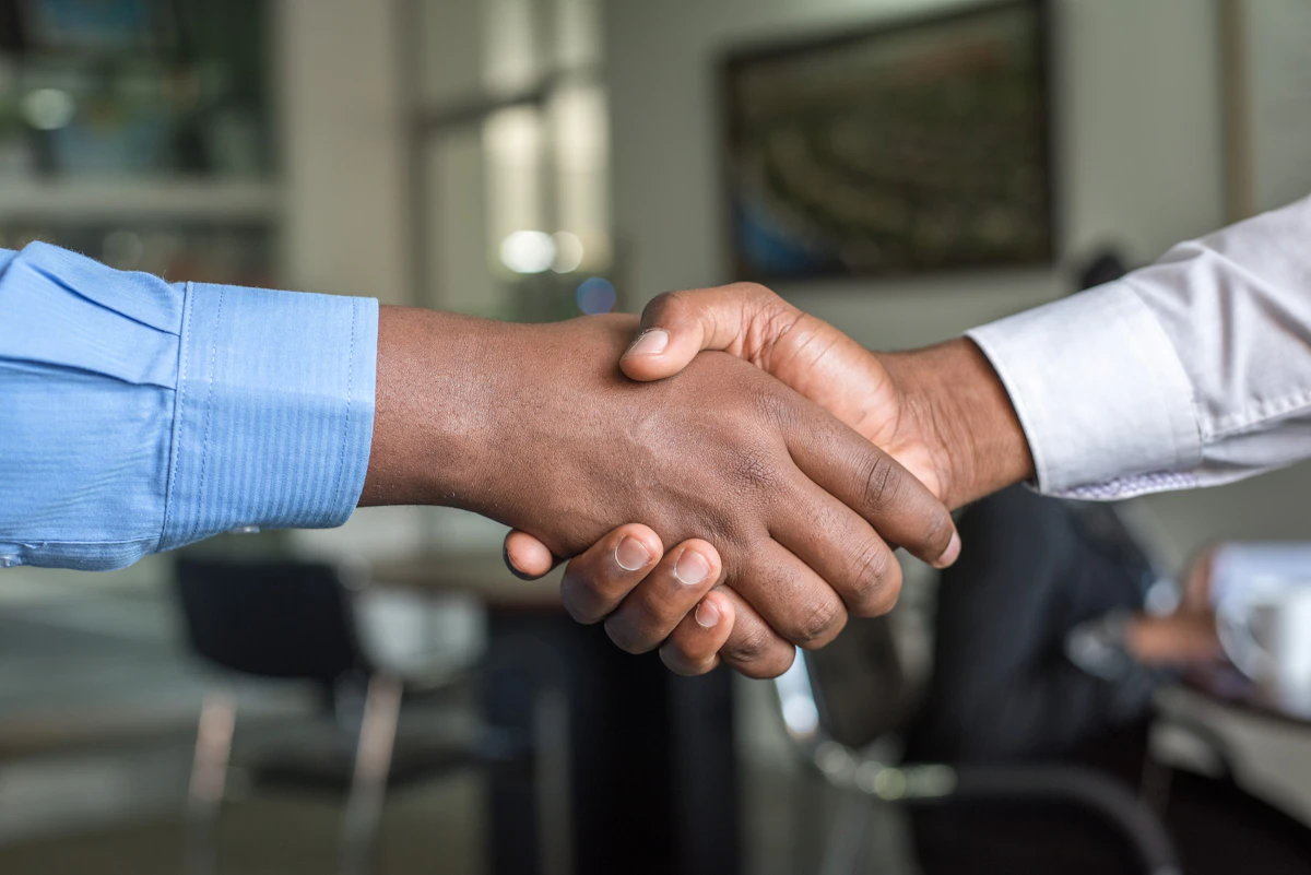 Solicitor and client shaking hands over a residential conveyancing transaction